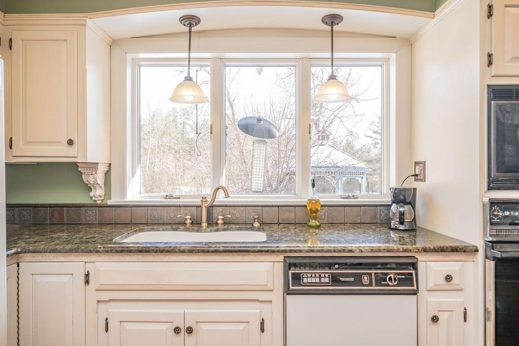 15 Fenton Road Monson, MA 01057 - Photo 24 of 41 a kitchen with granite countertop a stove a sink and white cabinets