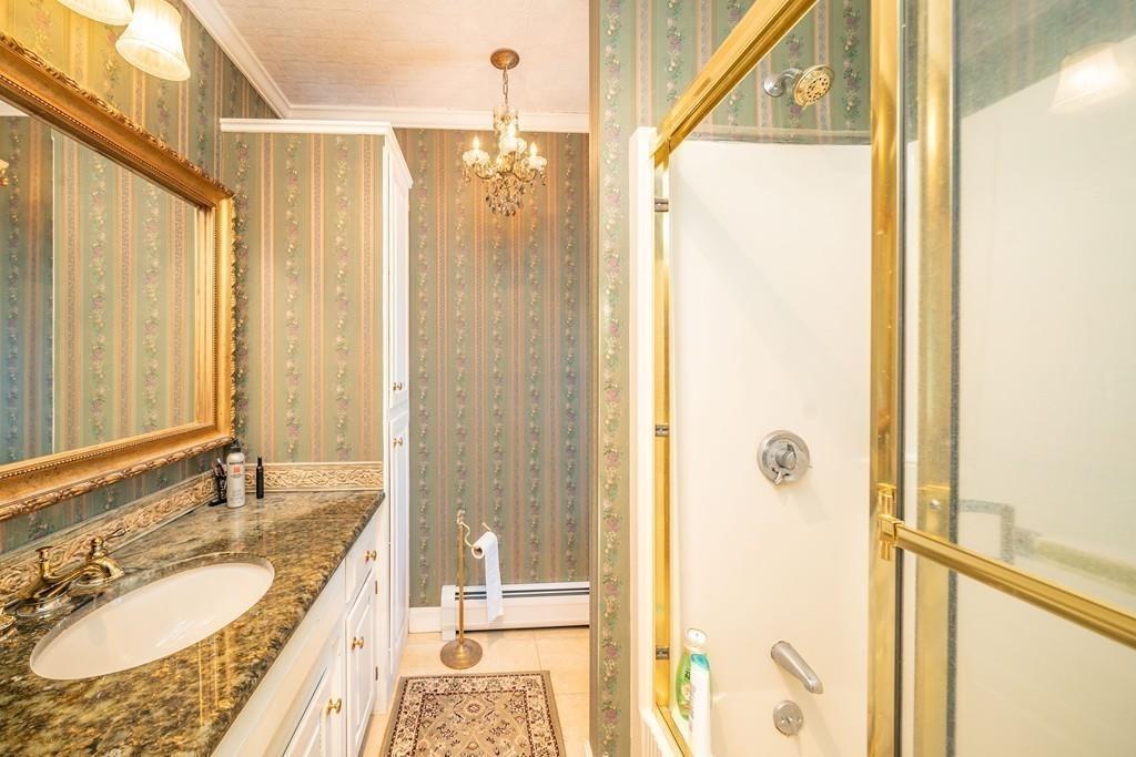 15 Fenton Road Monson, MA 01057 - Photo 34 of 41 a bathroom with a granite countertop sink a mirror and a shower