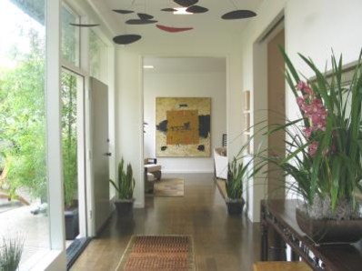 a view of entryway with a floor to ceiling window and wooden floor