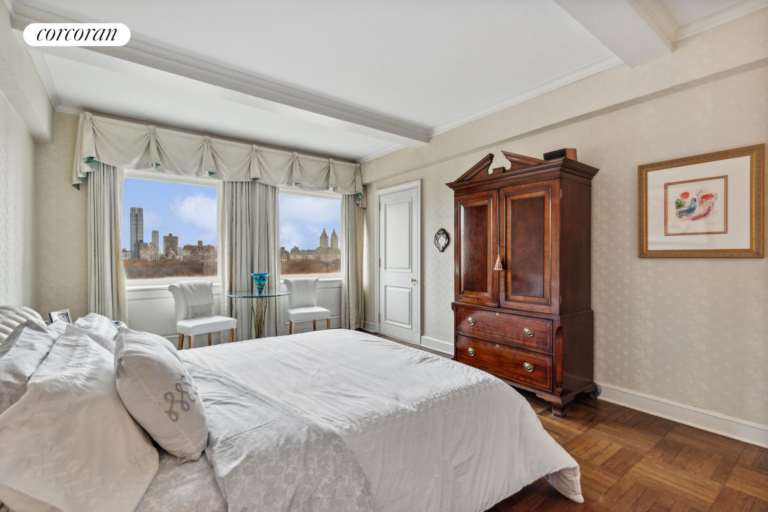 875 5th Avenue, Unit 12B Manhattan, NY 10065 - Photo 14 of 23 a bedroom with a large bed and dresser with mirror