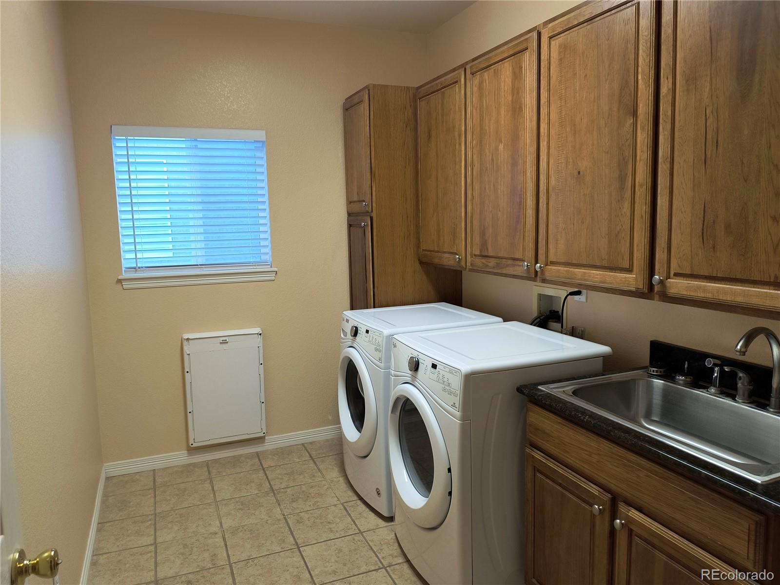 10145 Charissglen Lane Highlands Ranch, CO 80126 - Photo 13 of 39 a utility room with dryer and washer