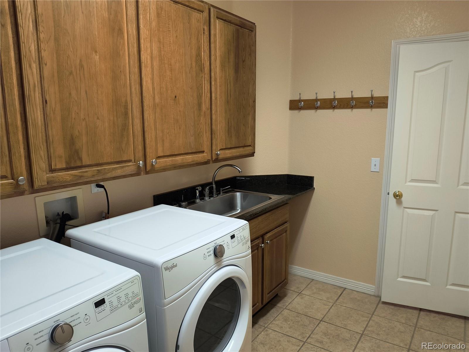 10145 Charissglen Lane Highlands Ranch, CO 80126 - Photo 14 of 39 a utility room with dryer and washer