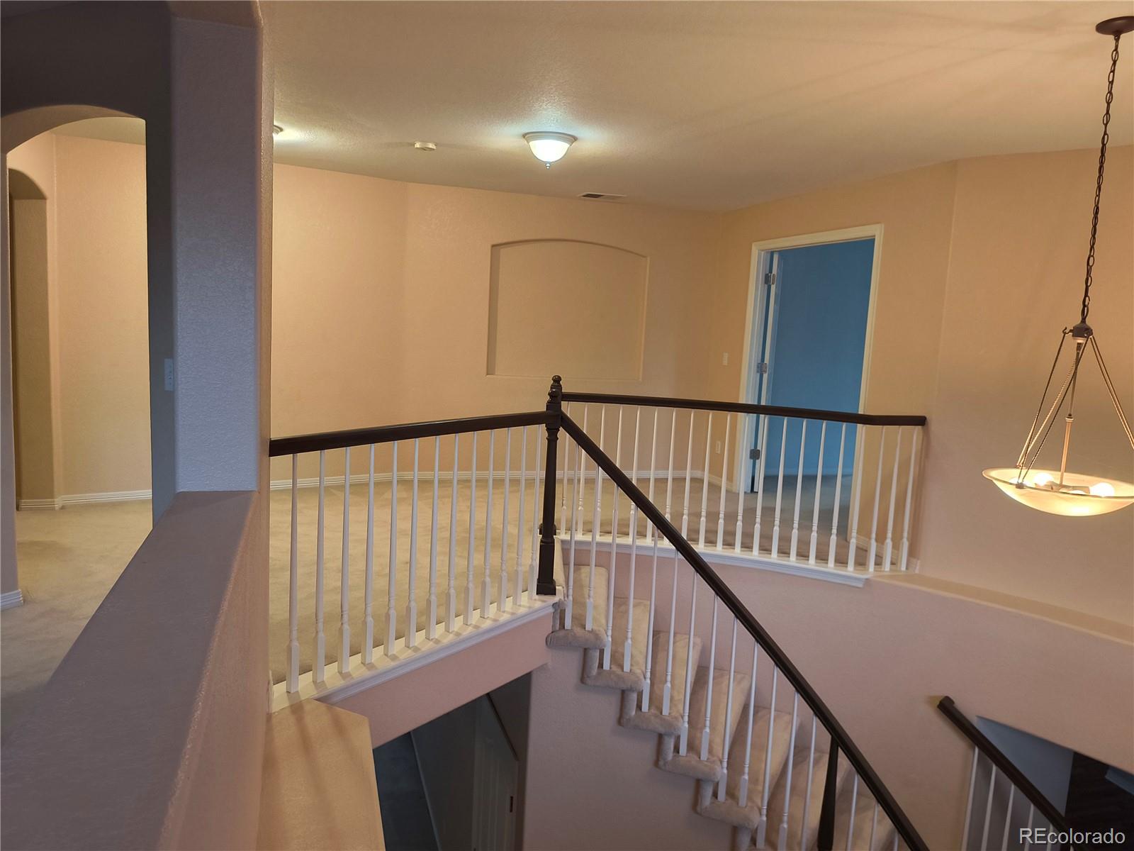 10145 Charissglen Lane Highlands Ranch, CO 80126 - Photo 15 of 39 a view of staircase with wooden floor and fan