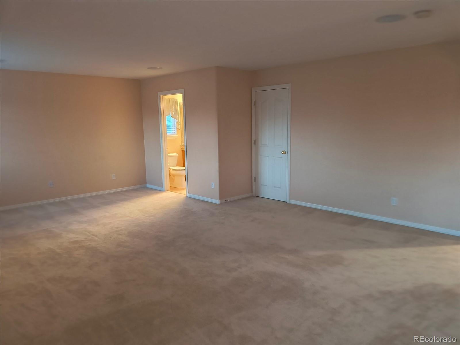 10145 Charissglen Lane Highlands Ranch, CO 80126 - Photo 17 of 39 a view of an empty room with window and bathroom