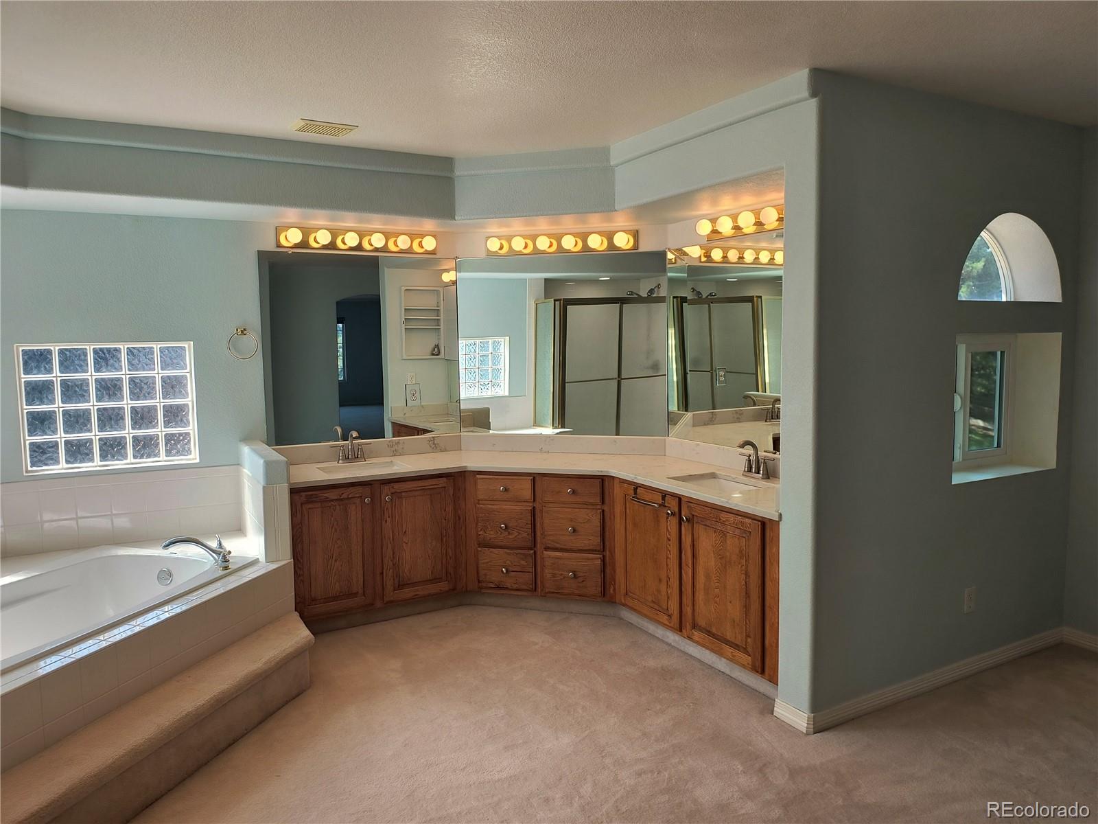 10145 Charissglen Lane Highlands Ranch, CO 80126 - Photo 21 of 39 a large bathroom with a large tub and sink