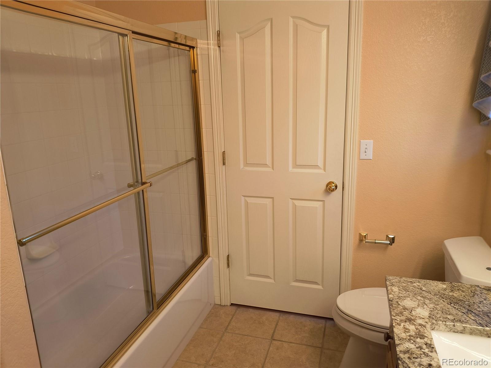 10145 Charissglen Lane Highlands Ranch, CO 80126 - Photo 29 of 39 a bathroom with a shower and a toilet