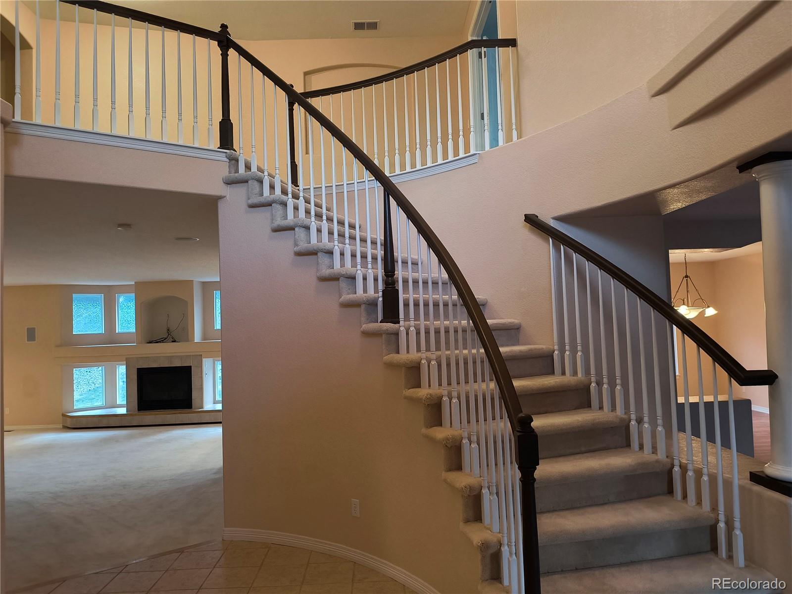 10145 Charissglen Lane Highlands Ranch, CO 80126 - Photo 3 of 39 a view of entryway and hall with wooden floor