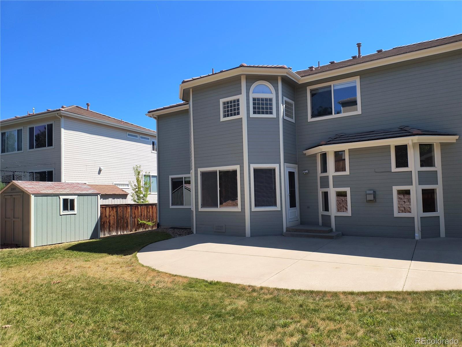 10145 Charissglen Lane Highlands Ranch, CO 80126 - Photo 34 of 39 a front view of a house with a yard