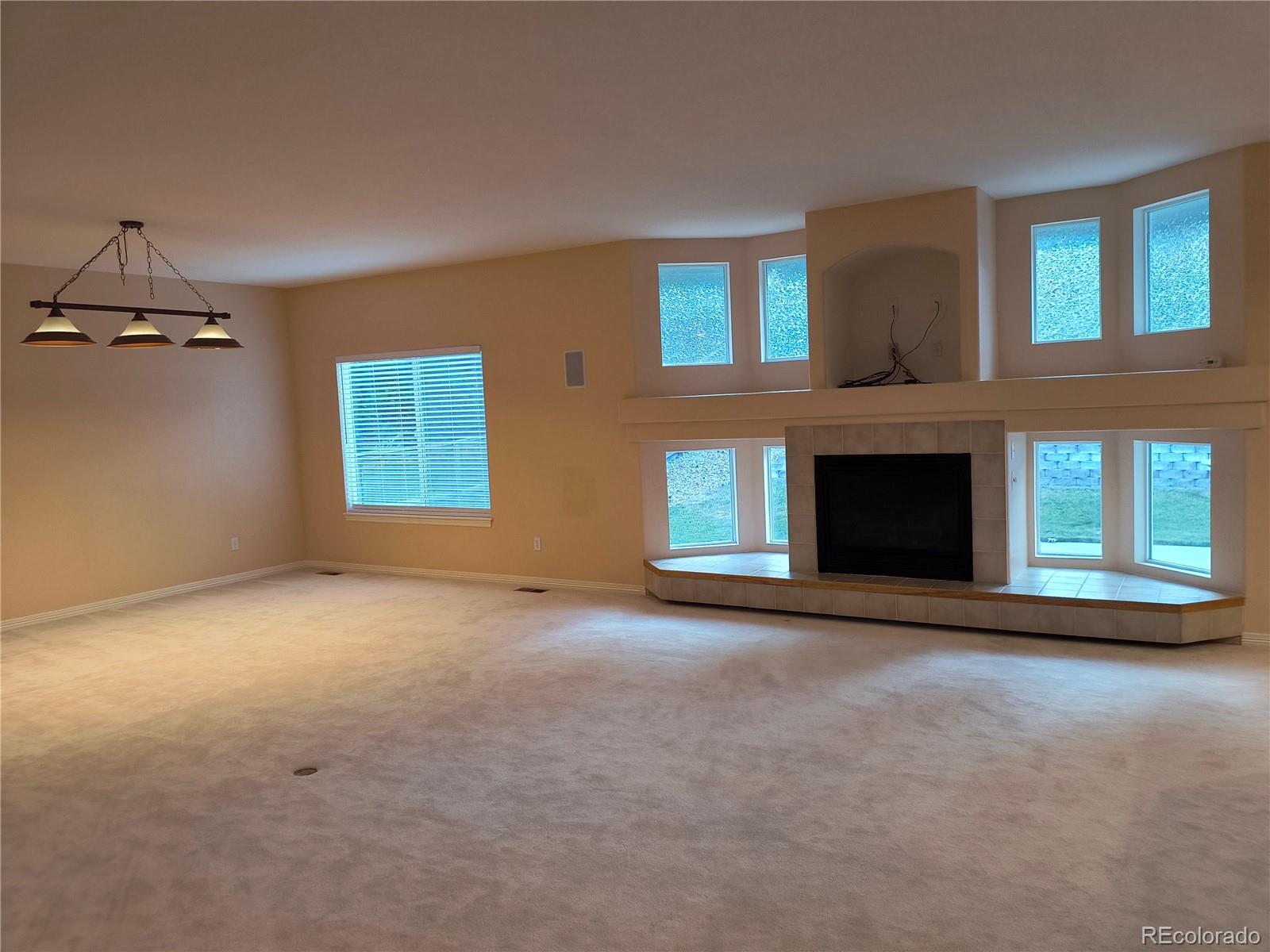 10145 Charissglen Lane Highlands Ranch, CO 80126 - Photo 4 of 39 a view of empty room with a fireplace