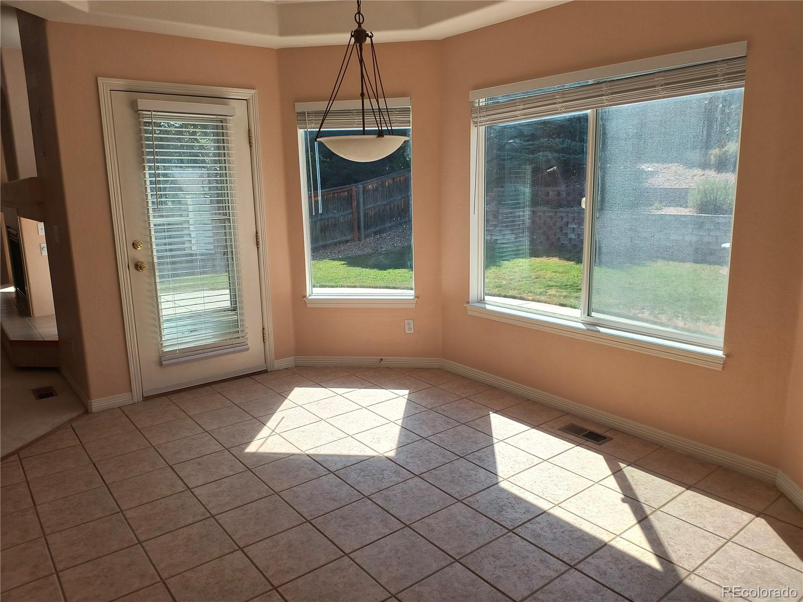 10145 Charissglen Lane Highlands Ranch, CO 80126 - Photo 8 of 39 a view of an empty room with windows