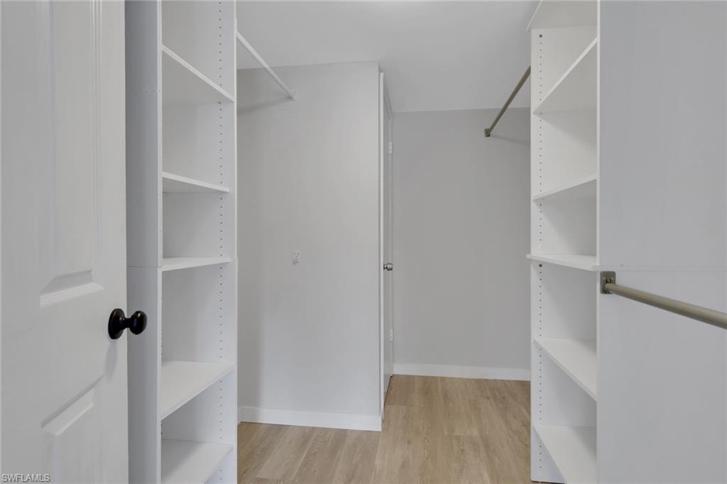 5499 Rattlesnake Hamm Road, Unit A207 Naples, FL 34113 - Photo 16 of 32 a view of walk in closet with empty racks