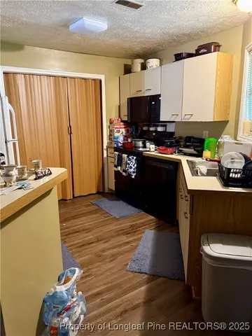 a kitchen with a stove a refrigerator and a sink