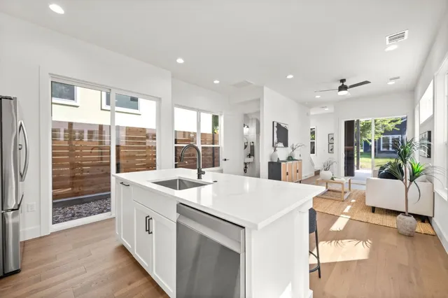 a kitchen with stainless steel appliances granite countertop a stove and a sink