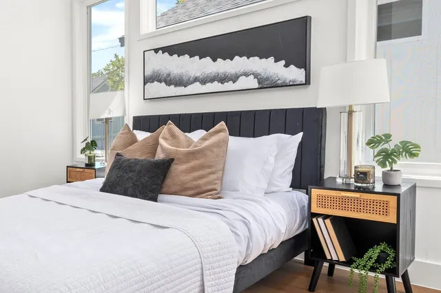 a bedroom with a bed and table chair