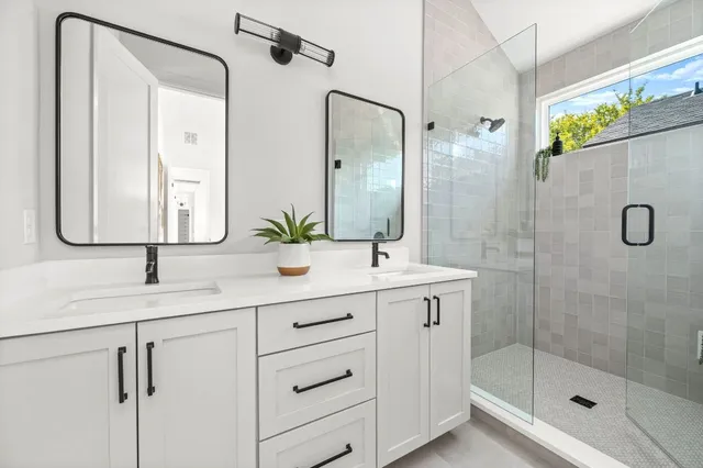 a bathroom with a shower sink and mirror