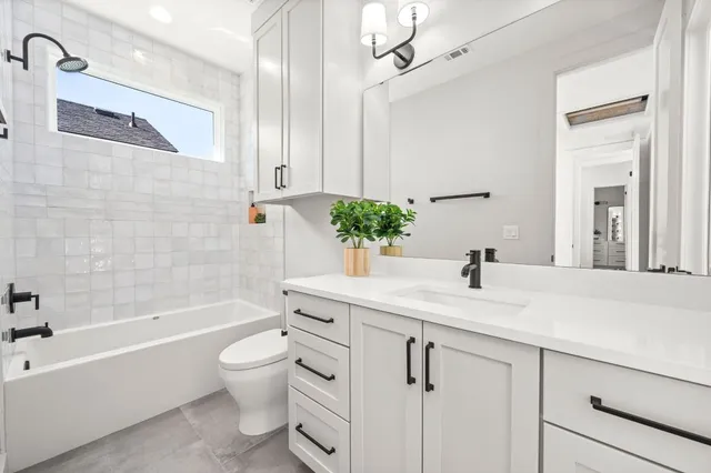 a bathroom with a tub and shower