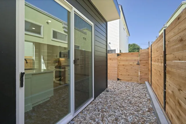 a view of a porch with a door and wooden floor