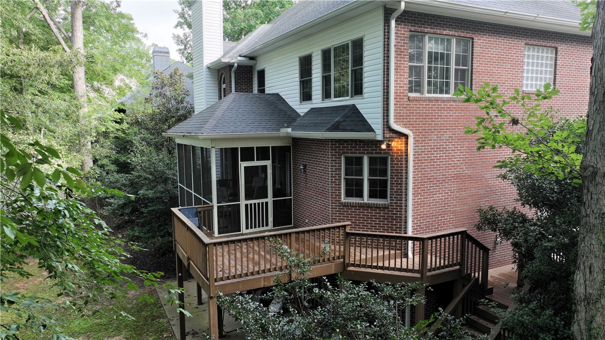 106 Red Maple Way Clemson, SC 29631 - Photo 39 of 49 A spacious wooden deck and screened porch sit beneath the brick exterior of this home.