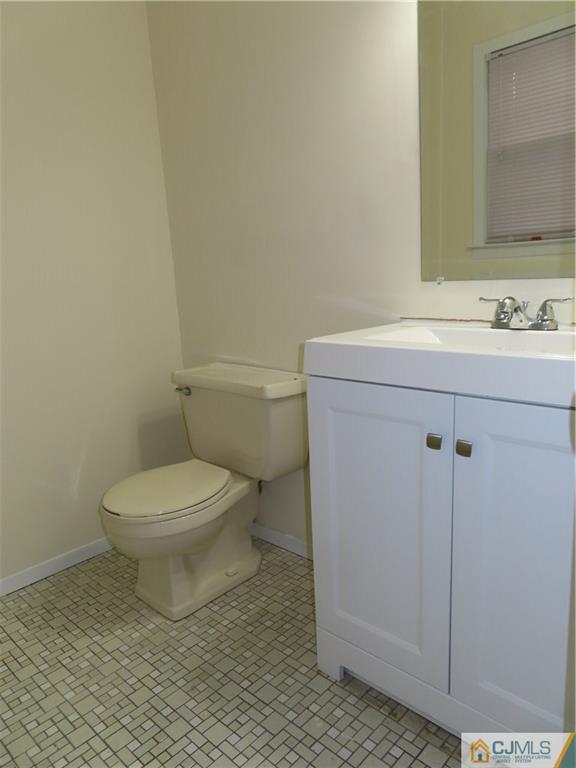 499 Harding Road Old Bridge, NJ 08879 - Photo 12 of 18 a bathroom with a toilet a sink and mirror