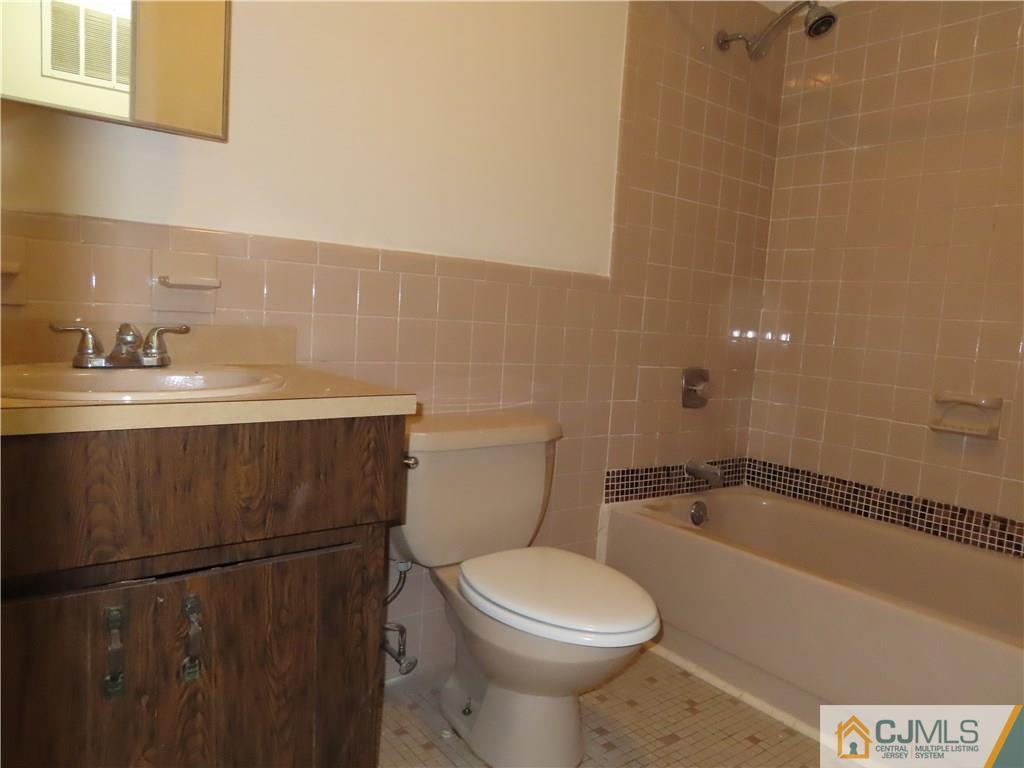 499 Harding Road Old Bridge, NJ 08879 - Photo 16 of 18 a bathroom with a sink a toilet and shower