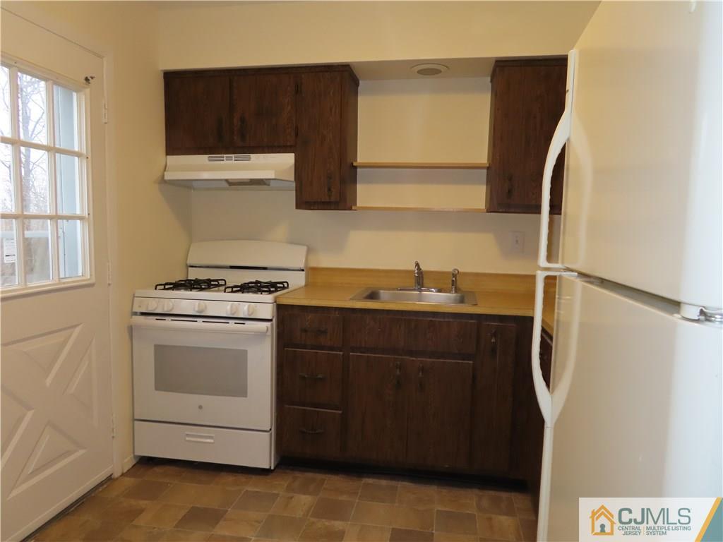 499 Harding Road Old Bridge, NJ 08879 - Photo 5 of 18 a kitchen with a sink and a stove