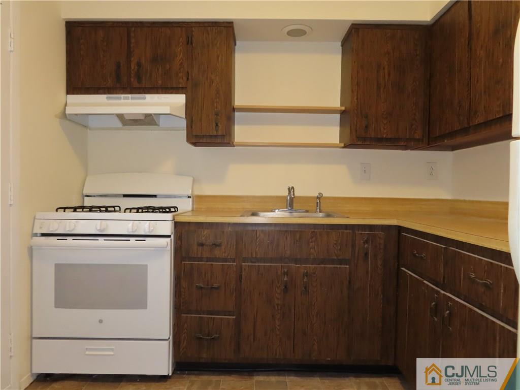 499 Harding Road Old Bridge, NJ 08879 - Photo 6 of 18 a kitchen with a cabinets and white stove