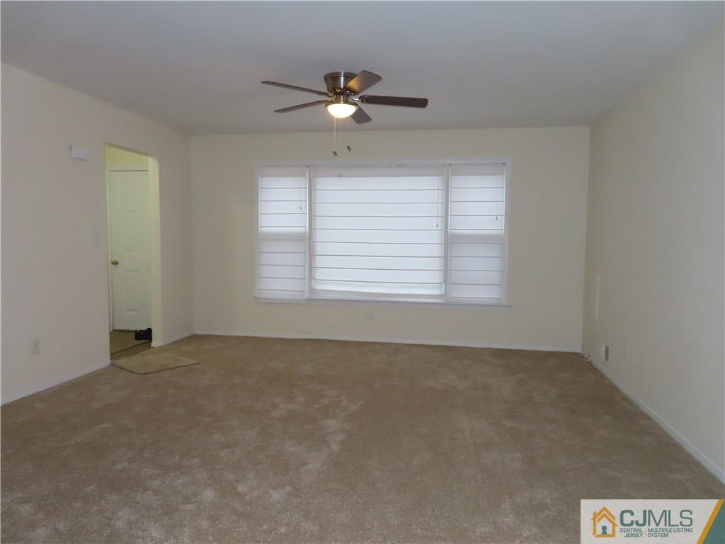 499 Harding Road Old Bridge, NJ 08879 - Photo 8 of 18 an empty room with a window and a ceiling fan