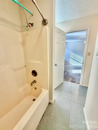 a bathroom with a bathtub and shower