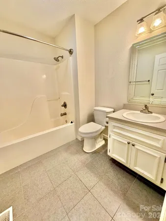 a bathroom with a toilet a sink and bathtub