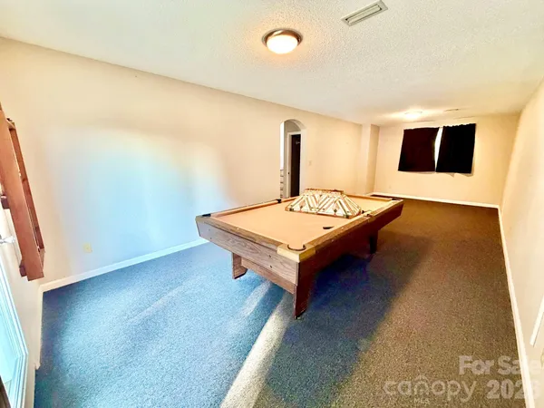 a living room with hard wood floors and a table