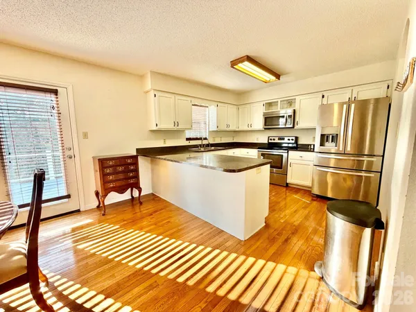 a kitchen with stainless steel appliances a stove a sink and a refrigerator