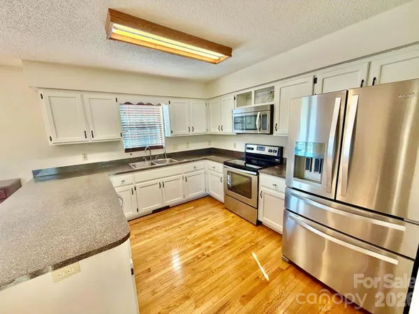 a kitchen with a refrigerator and a sink