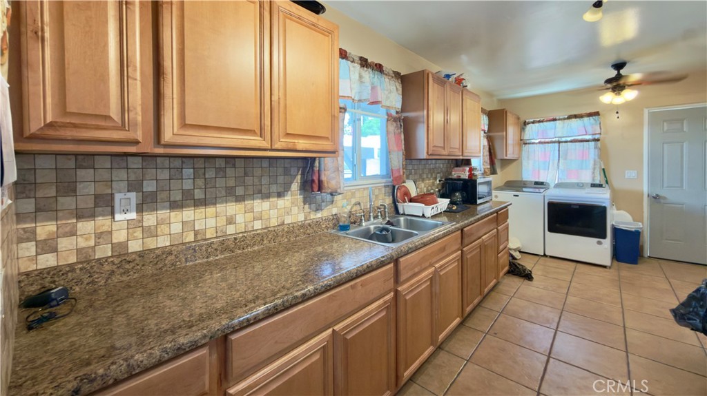 10861 Jamie Avenue Pacoima, CA 91331 - Photo 17 of 31 a kitchen with stainless steel appliances granite countertop a sink stove and cabinets