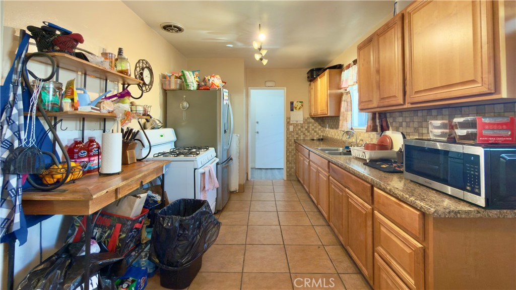 10861 Jamie Avenue Pacoima, CA 91331 - Photo 19 of 31 a kitchen with stainless steel appliances granite countertop a sink and cabinets