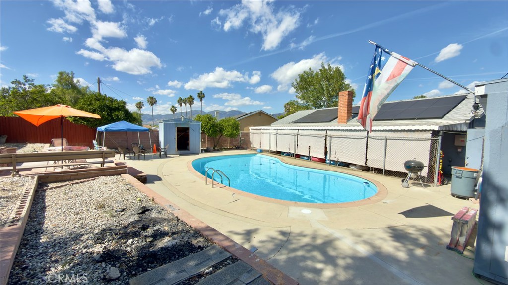 10861 Jamie Avenue Pacoima, CA 91331 - Photo 26 of 31 a swimming pool with outdoor seating and yard