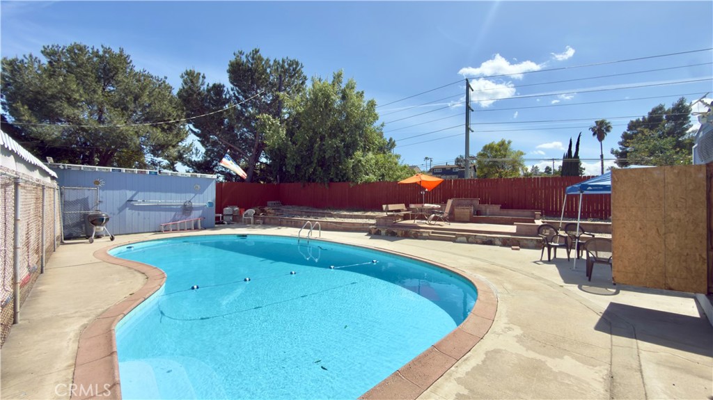 10861 Jamie Avenue Pacoima, CA 91331 - Photo 27 of 31 a view of a swimming pool with a patio and fire pit
