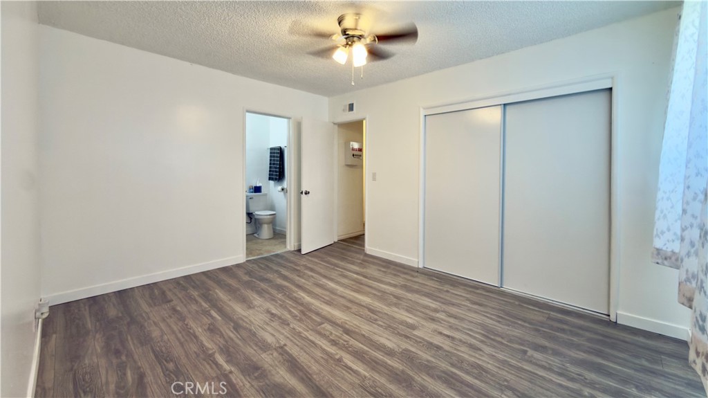 10861 Jamie Avenue Pacoima, CA 91331 - Photo 6 of 31 a view of an empty room with wooden floor and a ceiling fan