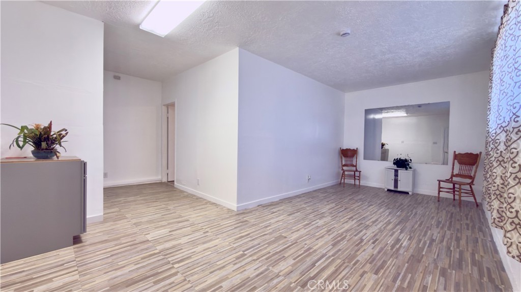 10861 Jamie Avenue Pacoima, CA 91331 - Photo 9 of 31 a view of room with furniture and wooden floor