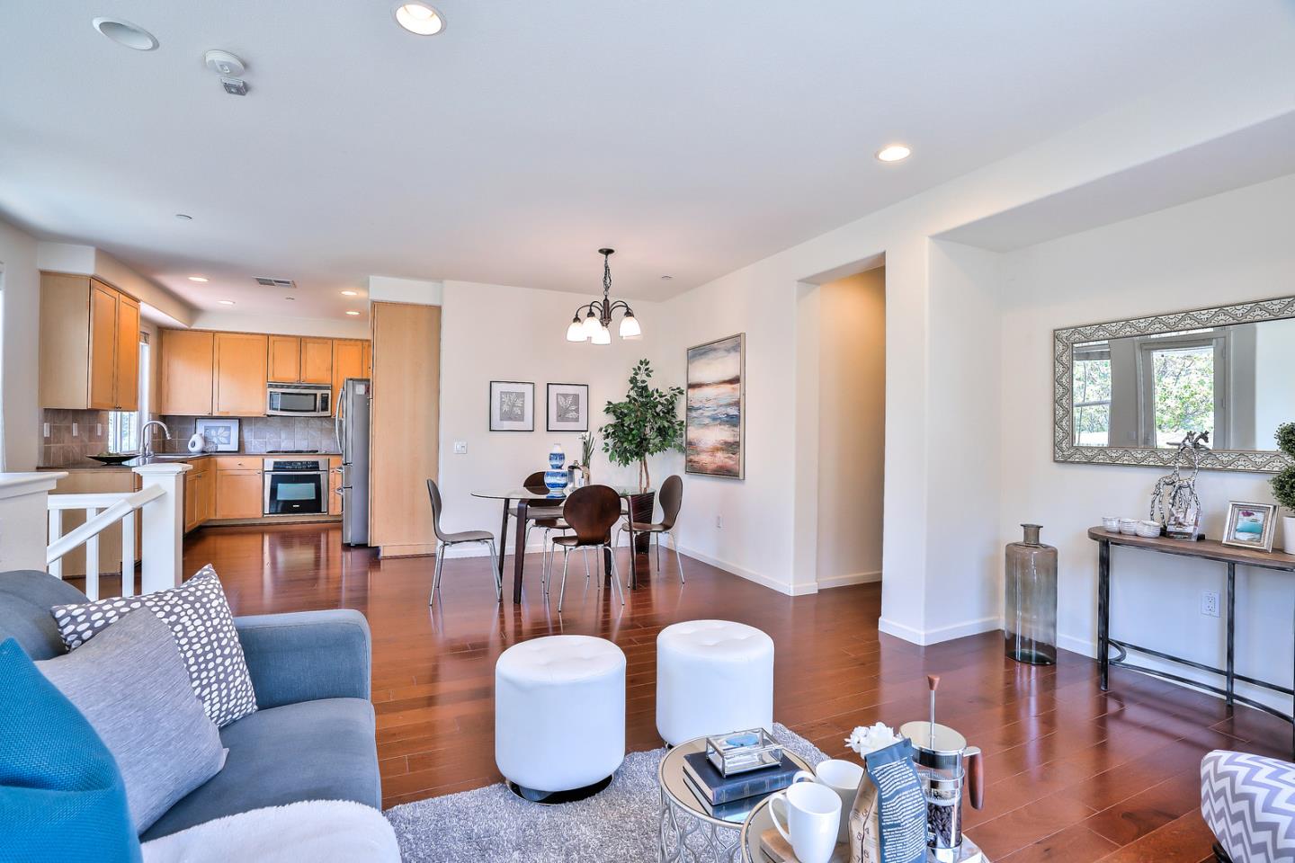 1088 Vida Larga Loop Milpitas, CA 95035 - Photo 6 of 29 a living room with furniture kitchen view and a chandelier