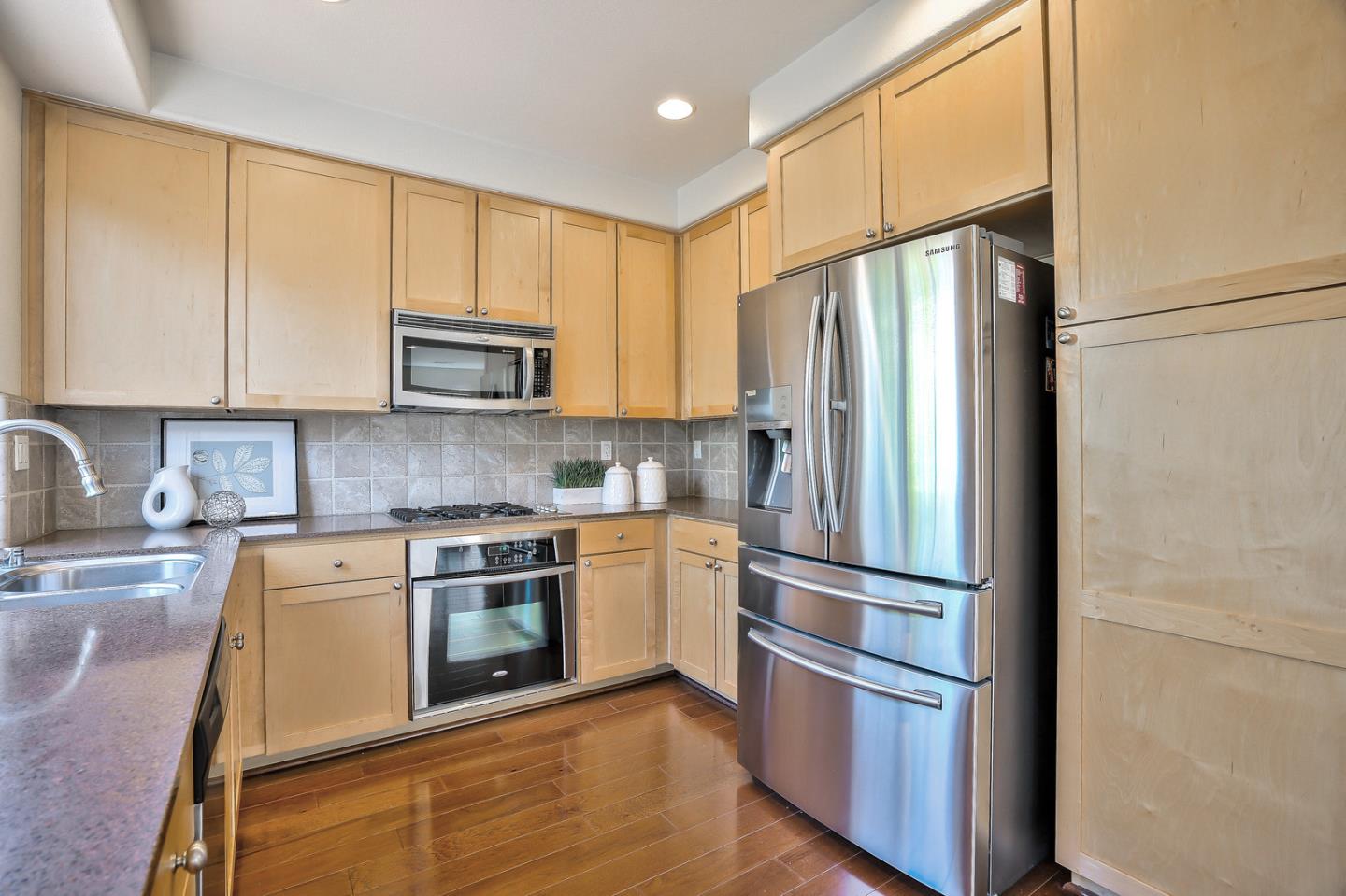 1088 Vida Larga Loop Milpitas, CA 95035 - Photo 10 of 29 a kitchen with a refrigerator stove and microwave