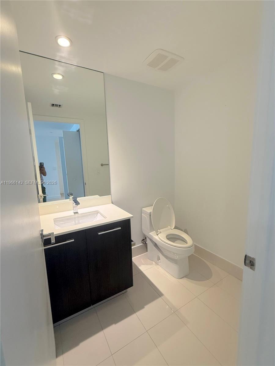 55 Southwest 9th Street, Unit 1809 Miami, FL 33130 - Photo 11 of 12 a bathroom with a sink and a toilet