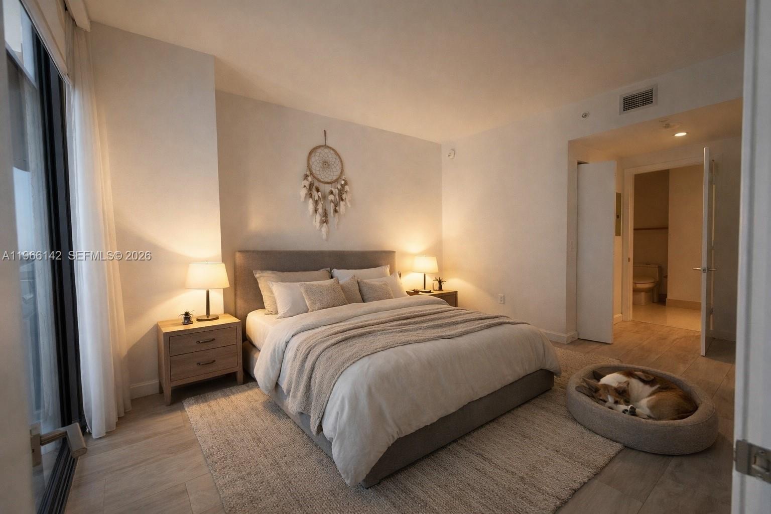 55 Southwest 9th Street, Unit 1809 Miami, FL 33130 - Photo 4 of 12 a bedroom with a bed and a wall painting