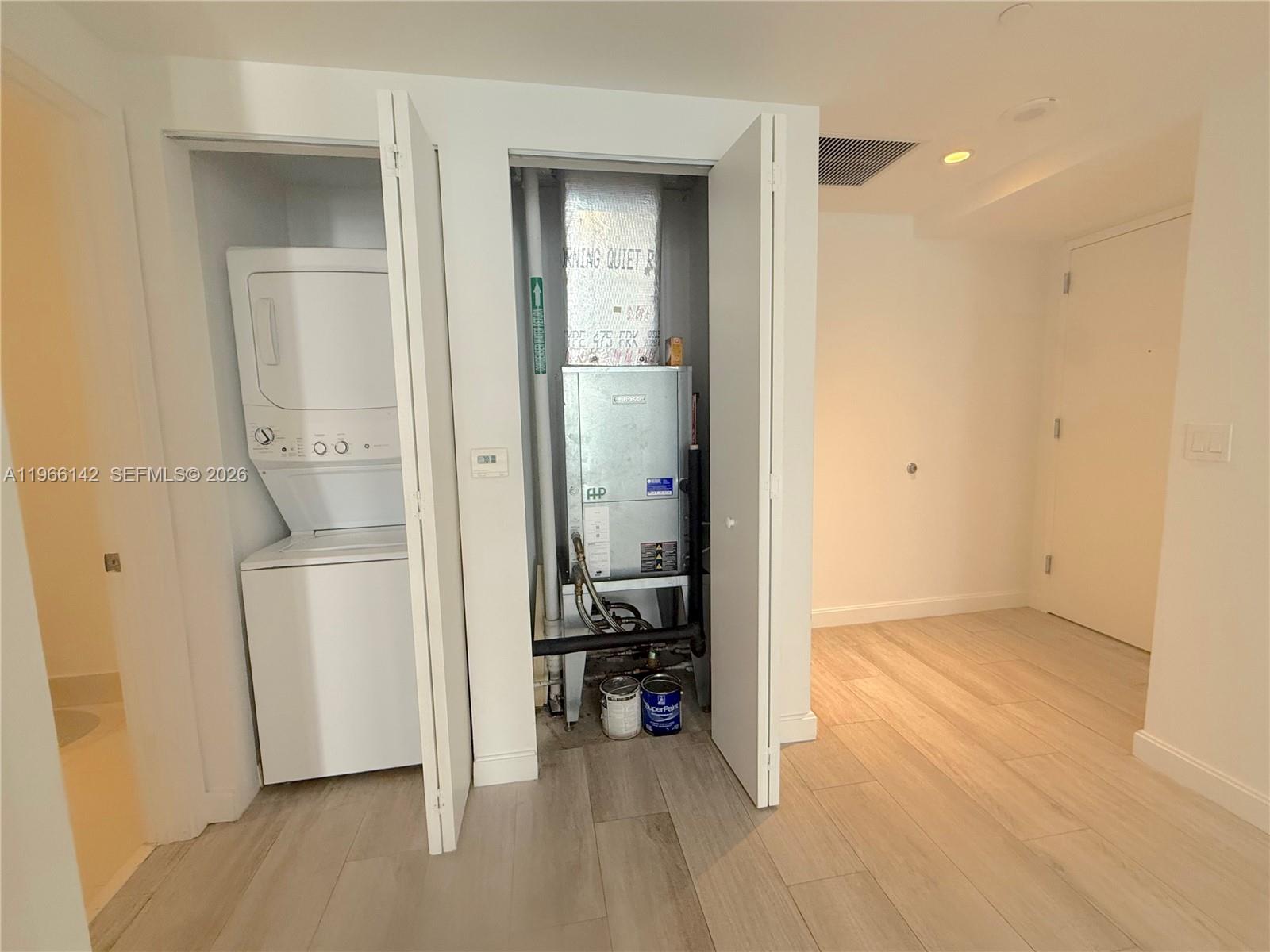 55 Southwest 9th Street, Unit 1809 Miami, FL 33130 - Photo 5 of 12 a view of a hallway with wooden floor and a bathroom