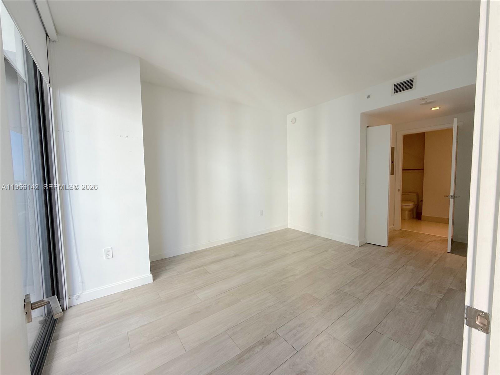 55 Southwest 9th Street, Unit 1809 Miami, FL 33130 - Photo 6 of 12 an empty room with closet