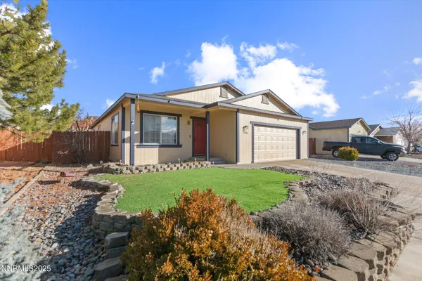 a front view of a house with a garden and yard