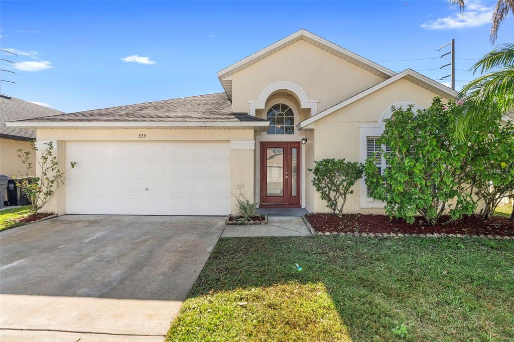 559 Saddle Ridge Drive Davenport, FL 33896 - Photo 1 of 42 a view of a house with a yard