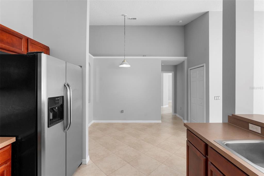 559 Saddle Ridge Drive Davenport, FL 33896 - Photo 11 of 42 a view of a kitchen cabinets and refrigerator