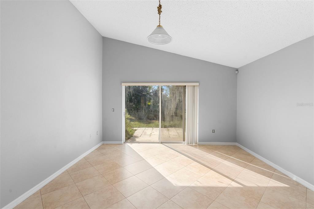 559 Saddle Ridge Drive Davenport, FL 33896 - Photo 14 of 42 a view of an empty room with a window