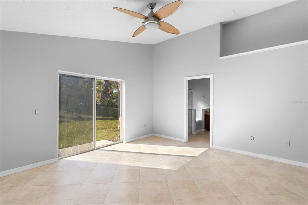 559 Saddle Ridge Drive Davenport, FL 33896 - Photo 19 of 42 a view of an empty room with window and chandelier fan