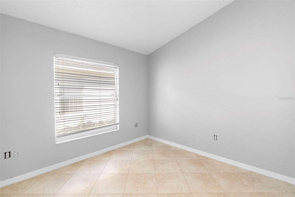 559 Saddle Ridge Drive Davenport, FL 33896 - Photo 23 of 42 a view of an empty room with a window